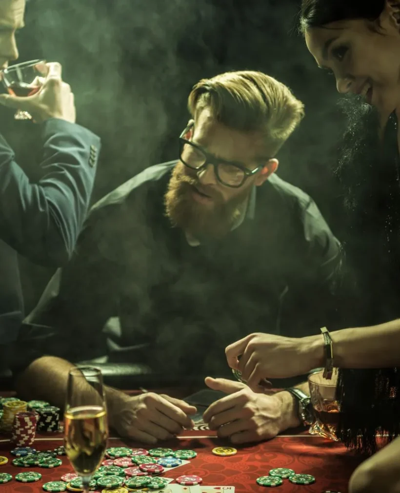 people with drinks playing poker